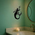 Mermaid Sea King Iron Relief Art mounted on teal bathroom wall above marble sink, ideal for coastal-themed home decor.