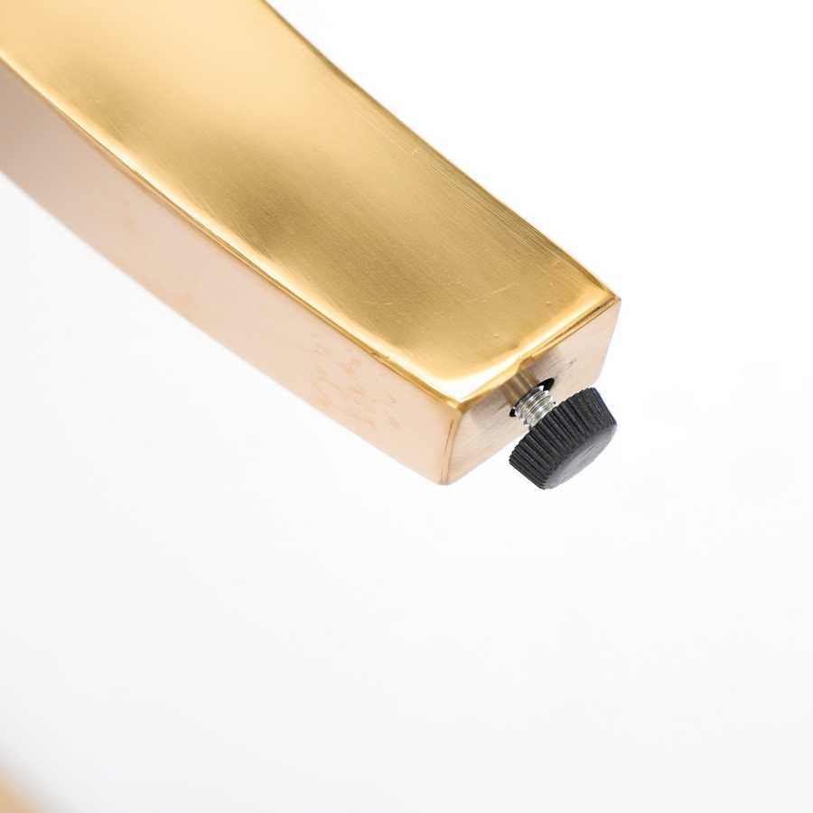 Gold-colored metal rod with a black knob on a white background