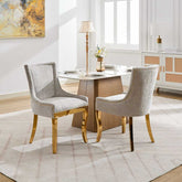 Dining room with a table and two gray chairs in a well-lit room.
