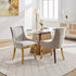 Dining room with a table and two gray chairs in a well-lit room.