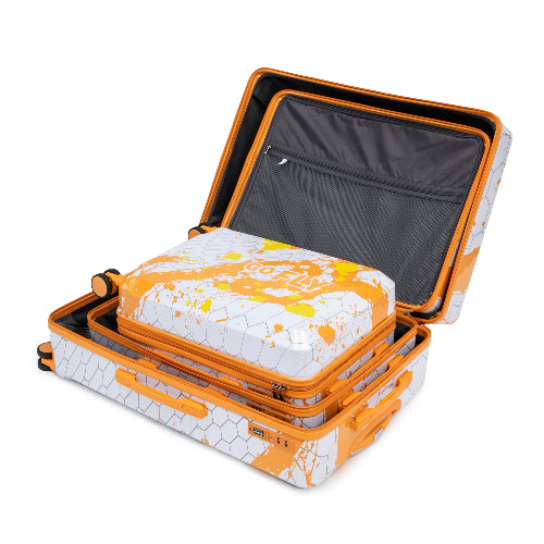 Set of stacked suitcases with geometric pattern and yellow accents on a white background