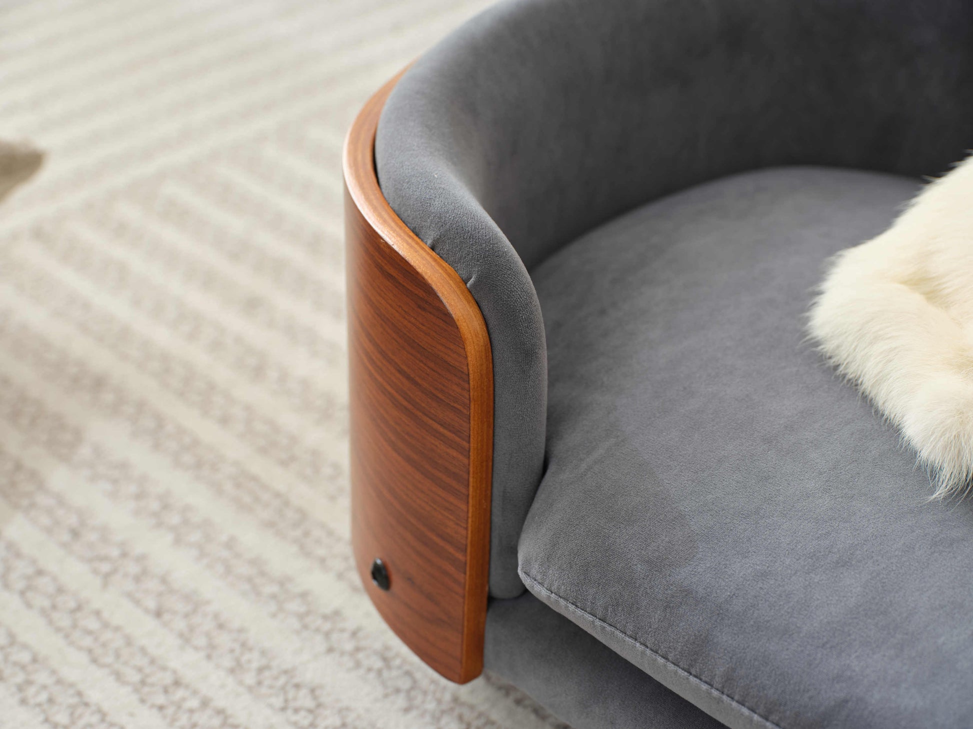 Angled view of plush velvet cushion and curved wood frame on Scandinavian Elevated Dog Bed, perfect for pet luxury.