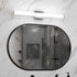 Bathroom with a large round mirror reflecting a shower area.