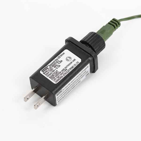 A black LED driver power adapter with a green cable, featuring a white label with technical specifications and two flat pins on a white background.