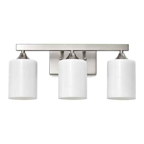 A three-light bathroom vanity wall sconce with a brushed nickel horizontal bar and three white cylindrical glass shades, shown against a plain white background.