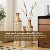Gold and white metal floor vases styled with dried branches, highlighting their artistic and versatile home decor use.