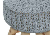Close-up of a textured gray cushion on a wooden stool.