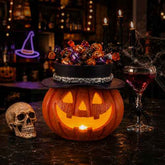 A Halloween-themed decorative scene on a dark tabletop with a carved jack-o&