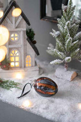 Egg Christmas ornaments in a snowy holiday display