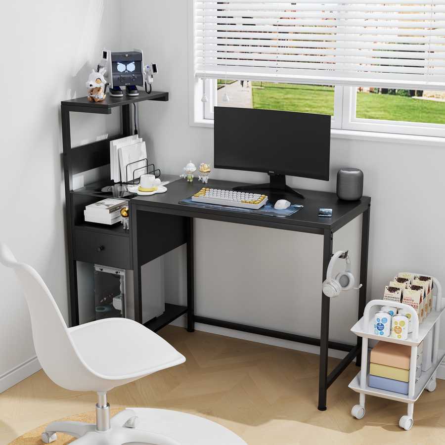 Computer desk with power outlet and USB ports in black, set up in a bright home office with reversible shelves and compact design.
