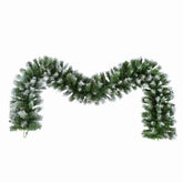 Artificial Christmas garland with snow effects on a white background