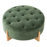 Green round ottoman with tufted design and wooden legs on a white background