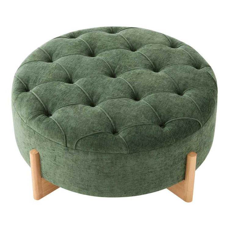 Green round ottoman with tufted design and wooden legs on a white background