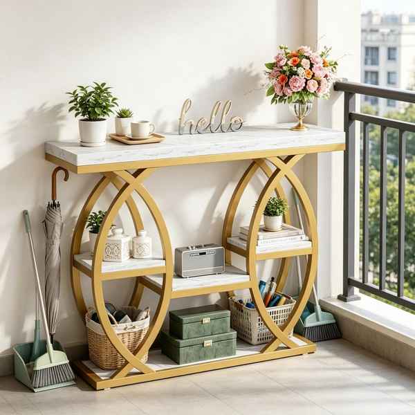 A gold console table with a white marble-patterned top and open shelves, styled in a bright entryway or balcony setting with plants, flowers, baskets, and decor.