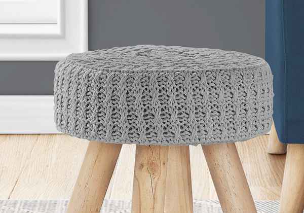 Gray knitted stool with wooden legs in a room setting