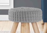 Gray knitted stool with wooden legs in a room setting