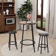 Compact 3-Piece Bar Table Set with 2 Stools placed near a window, perfect for small dining spaces with its sleek black metal frame and marble-style top.