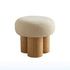 Stool with beige cushioned top and wooden legs on a white background