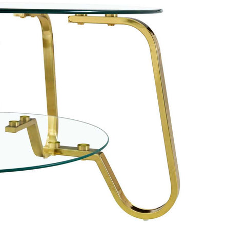 Side view of vintage coffee table's gold metal leg and glass shelf, highlighting modern curved frame design.