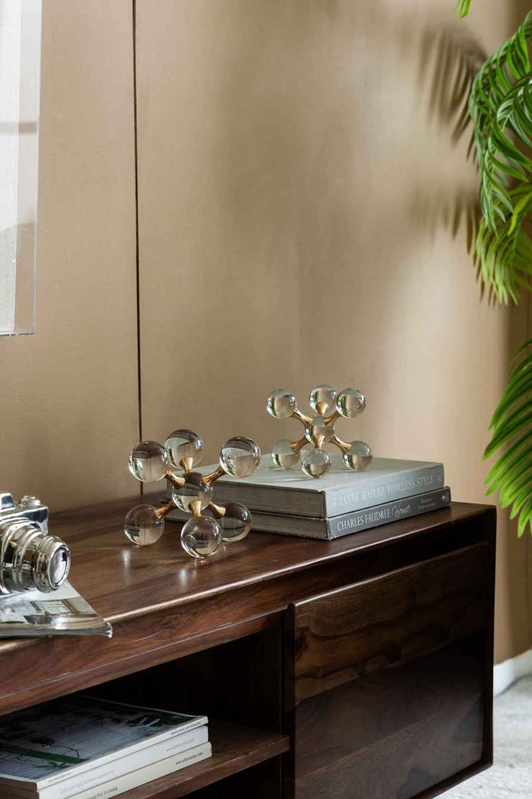 Wooden console table with decorative items against a beige wall