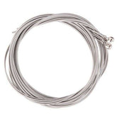 Coiled set of guitar strings on a white background