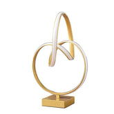 Decorative lamp with gold and white circular design on a white background