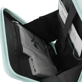 Close-up of the interior of a mint green and black organizer bag, showing a gray mesh pocket with a black butterfly graphic and a white paper insert.