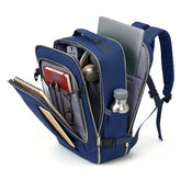 Blue backpack with compartments containing a laptop, notebook, and other items on a white background