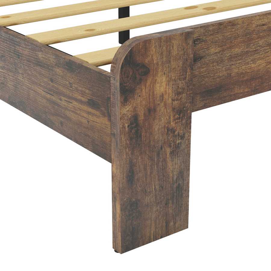 Detailed view of footboard corner on full size wood platform bed frame, highlighting rustic finish and durable construction.