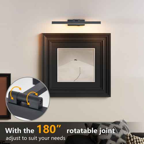 A modern wall-mounted light fixture with a rectangular black metal bar and warm white illumination, shown above a framed picture on a beige wall. An inset circle highlights the rotatable joint, and text at the bottom reads &