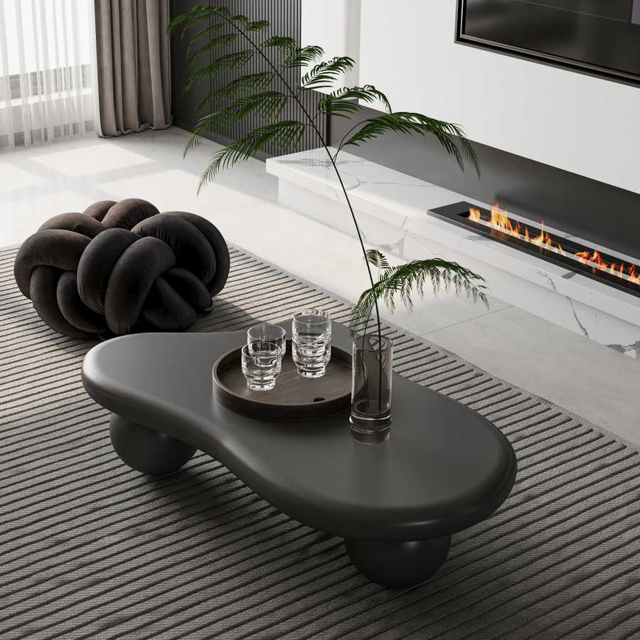 40 Inch Black Cloud Coffee Table with round legs in front of a fireplace, blending modern design and functionality for elegant interiors.