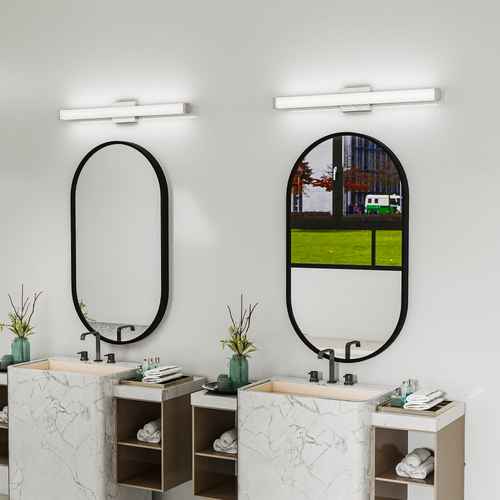 Bathroom with two vanity units and mirrors, featuring modern lighting fixtures.