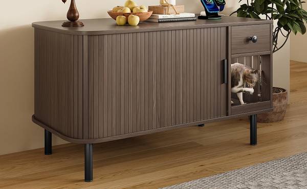 Side view of cat entering the litter box enclosure through slatted door, modern wood design with black legs.
