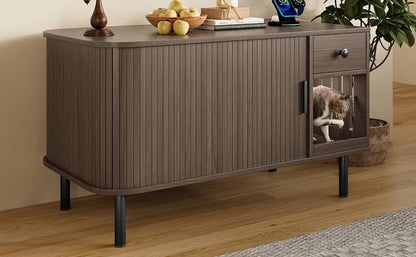 Side view of cat entering the litter box enclosure through slatted door, modern wood design with black legs.