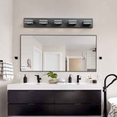 Bathroom vanity with mirror, lights, and various items on a neutral wall.