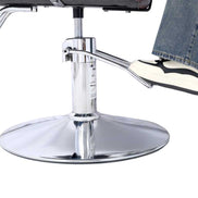Foot on chrome footrest of Heavy Duty Barber Chair, demonstrating comfort and support during salon services.