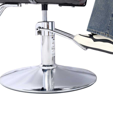 Foot on chrome footrest of Heavy Duty Barber Chair, demonstrating comfort and support during salon services.