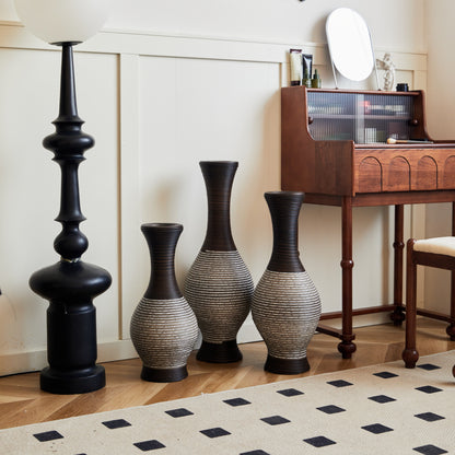 Elegant brown floor vase set of 3 made of durable PVC, styled beside a black floor lamp and wooden desk in a contemporary living space.