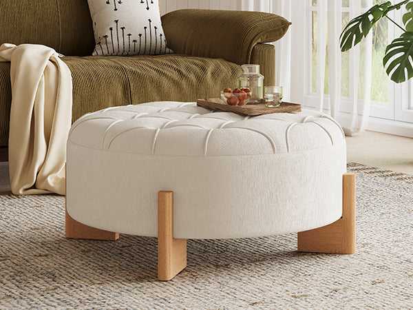 White ottoman with wooden legs in a living room setting