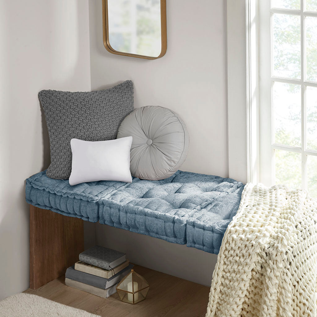 Nook with cushions and a blanket in a bright room