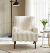 White upholstered armchair in a modern living room with a side table and lamp.