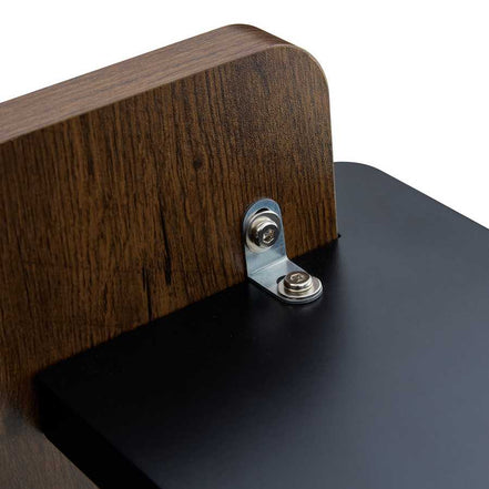 Close-up of metal bracket securing black leg to walnut MDF tabletop, highlighting the table’s durable and stable construction.