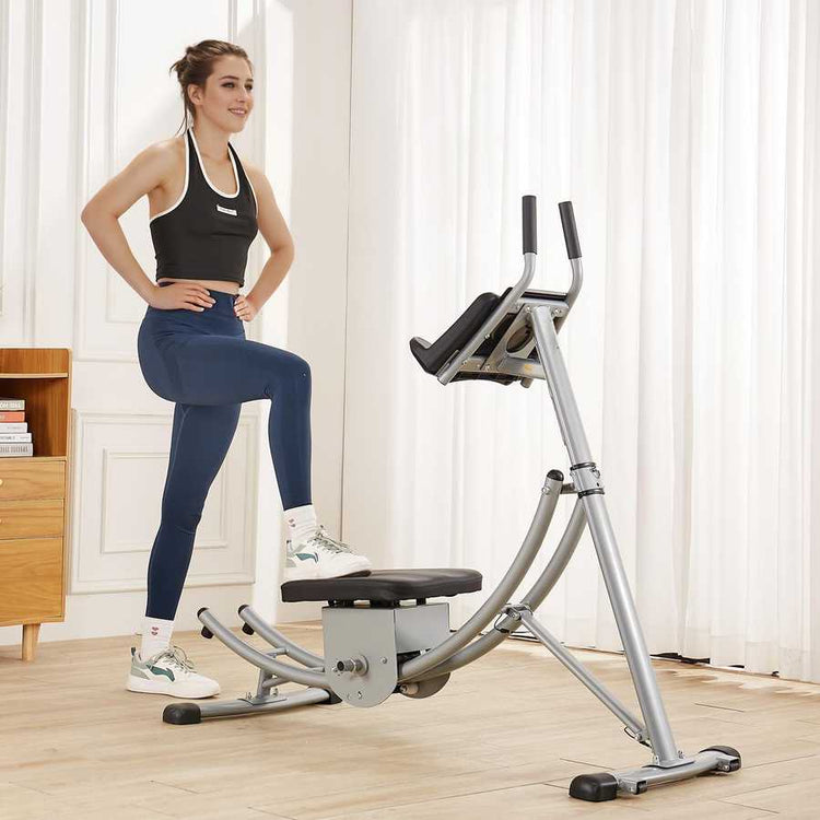 Woman using a home exercise machine in a bright room