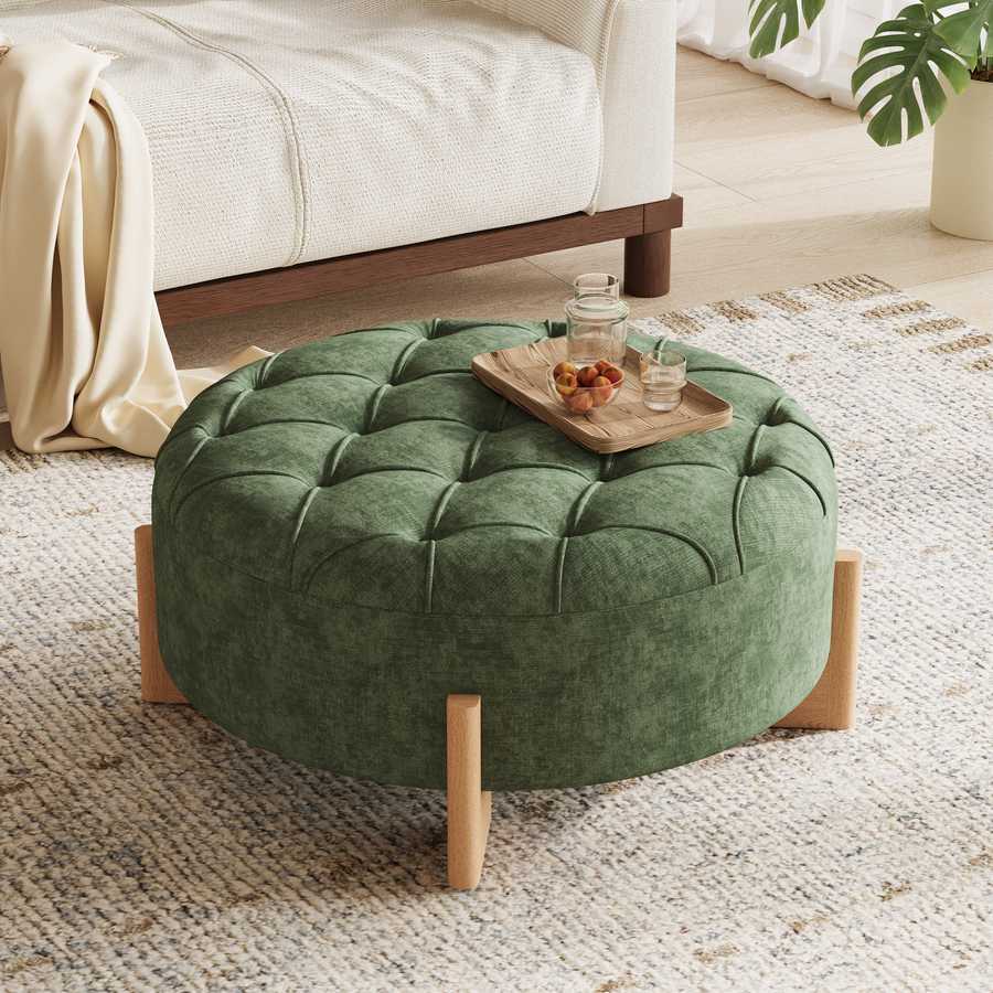 Green tufted ottoman with a wooden tray on a textured rug in a living room.