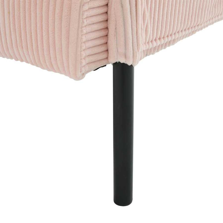 Close-up of a pink upholstered chair with a black metal leg on a white background