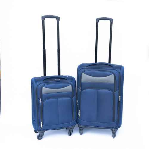 Blue rolling suitcase with telescopic handle and four spinner wheels, made of durable fabric, suitable for travel.