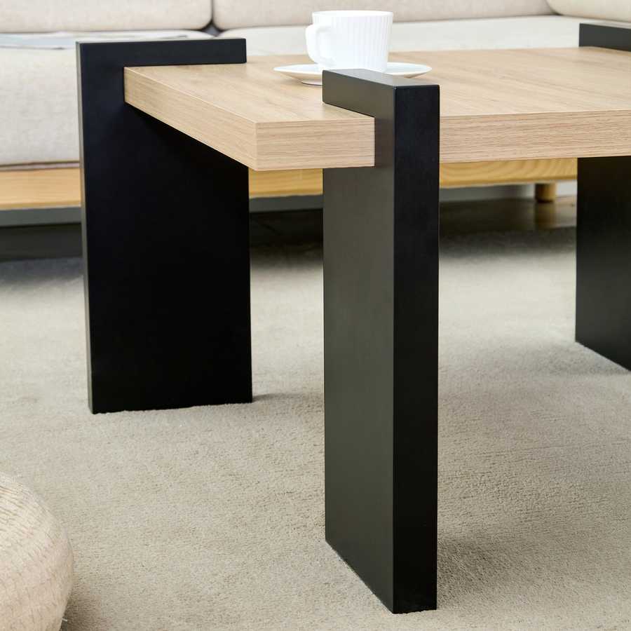 Side view of MDF Coffee Table with black legs and wood top, emphasizing its modern aesthetic and clean design lines.