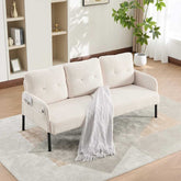 Beige sofa with a white blanket on a patterned rug in a living room setting.