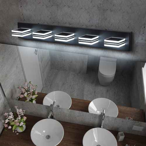 Bathroom setup with a mirror and lights above it, featuring white sinks and a toilet.