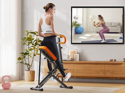 User performing squats on Squat Rowing Machine at home while following a virtual workout, ideal for full body fitness in small spaces.